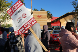 Workers picket outside the hotel. 