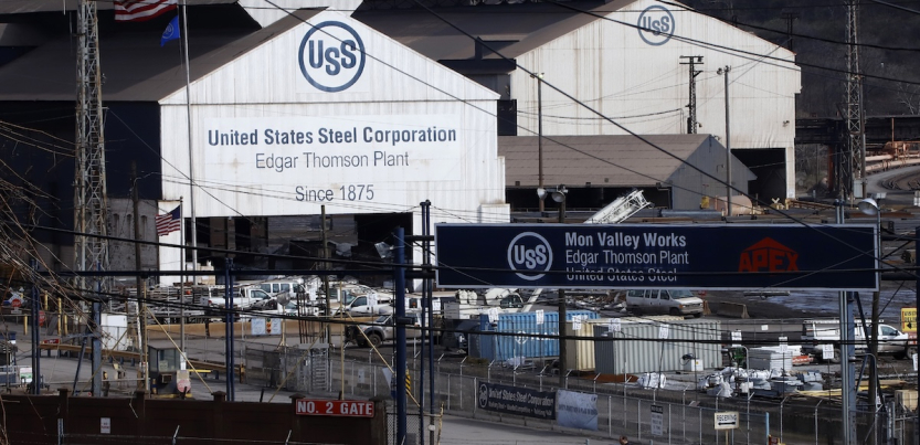 Two large white barn-shaped buildings with the U.S. Steel logo are shown.