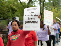 A CTU member holds a sign reading: "Fair contract now!" in Spanish