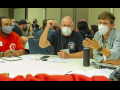 Four men sit around a table at the Labor Notes 2022 Conference during a workshop.