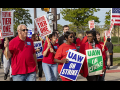 Crowd of GM workers on strike, marching.