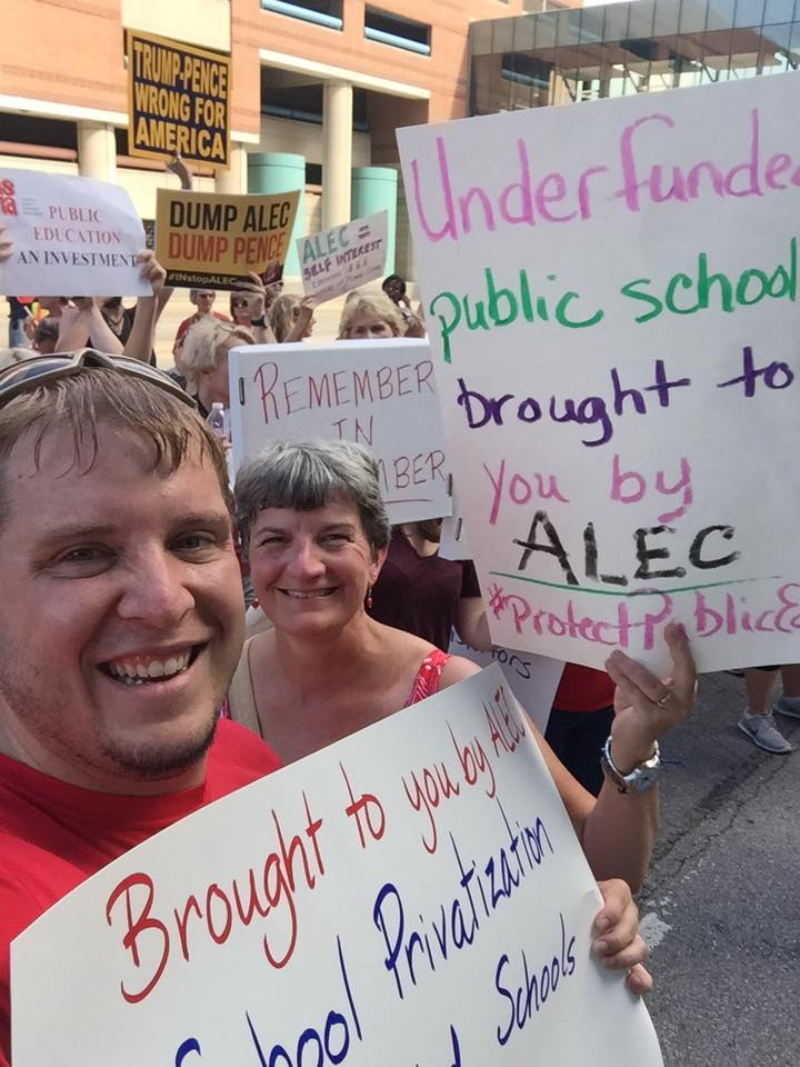 Members of the Maconaquah Education Association hold up signs to support teachers and public education.