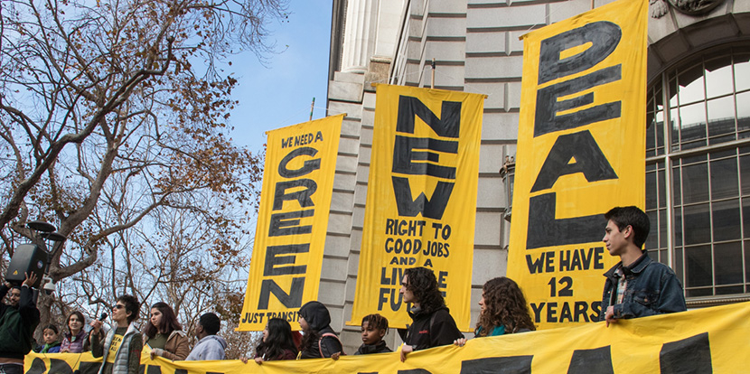 Green New Deal banners at rally