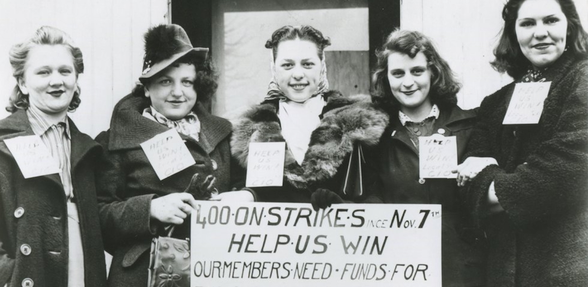 Five women in a black and white photo hold a sign saying “400 on strike since November 7 Our members need funds”