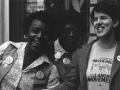 Multiracial group of activists standing next to each other and laughing.