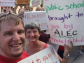 Members of the Maconaquah Education Association hold up signs to support teachers and public education.