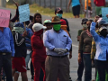 Group of protesters in Honduras assembled in the street with signs