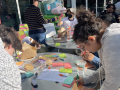 A group write colorful post-in at outside round tables--one says bereavement leave