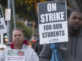 A white man and a Black man hold signs: "On Strike for Our Students; UTLA"