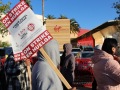 Workers picket outside the hotel. 