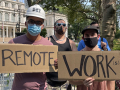 two protesters holding signs