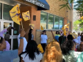 Workers with flags gather outside the glass-doored offices of Frontline in Cleveland